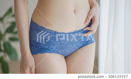 A woman in underwear touching her lower abdomen (diet / belly) A woman in underwear touching her lower abdomen (diet / belly) 106135557