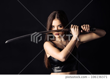 Beautiful asian woman with Japanese sword. Cropped image. 106136371