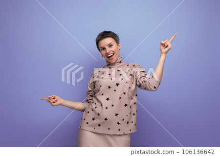 successful young caucasian boss woman with short hair in a skirt and blouse on a background with 106136642