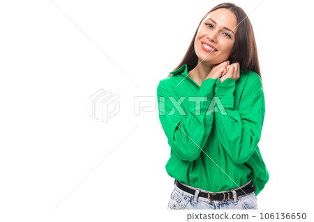 portrait of an adorable slim cute brown-eyed brunette woman dressed in a green shirt smiling on 106136650