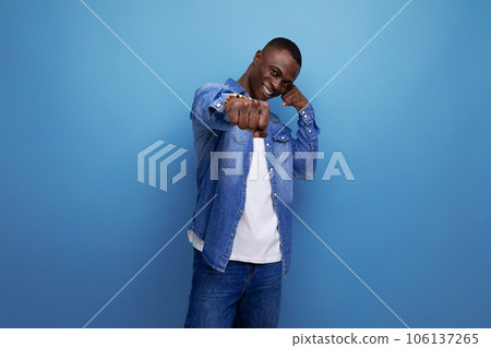 portrait of bright confident young attractive african man dressed in stylish denim clothes 106137265