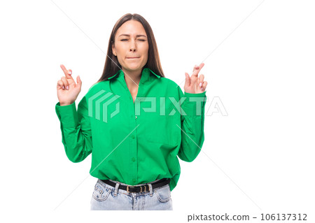 young 30 year old european brunette woman model with long hair and brown eyes crossed her fingers young 30 year old european brunette woman model with long hair and brown eyes crossed her fingers 106137312