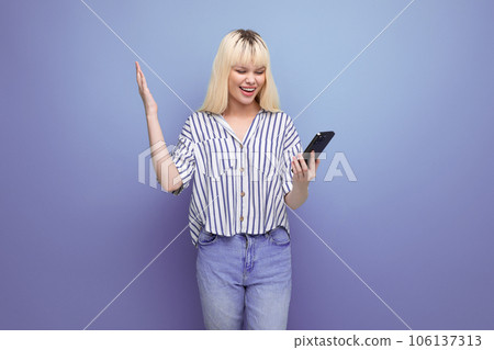 pretty slim blonde young lady in casual outfit talking on the phone in the studio pretty slim blonde young lady in casual outfit talking on the phone in the studio 106137313
