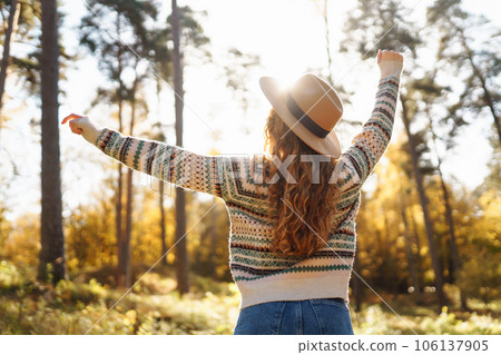 Outdoor atmospheric lifestyle. portrait of beautiful woman having fun in autumn forest. Warm autumn 106137905