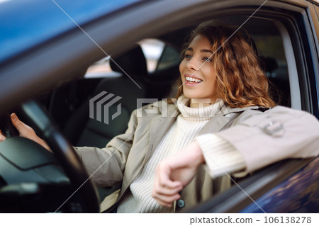 Young woman driving a car in the city. Car sharing, rental service or taxi app. Young woman driving a car in the city. Car sharing, rental service or taxi app. 106138278