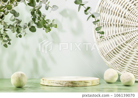 Empty wooden podium with laundry balls on blue background with eucalyptus leaves. Natural display for presentation. Eco friendly showcase for new home cleaning or laundry products and promotion sale Empty wooden podium with laundry balls on blue background with eucalyptus leaves. Natural display for presentation. Eco friendly showcase for new home cleaning or laundry products and promotion sale 106139070