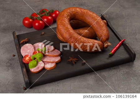 krakow sausage smoked boiled on a dark wooden board 106139164