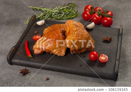 smoked boiled chicken thigh on a dark wooden board smoked boiled chicken thigh on a dark wooden board 106139165