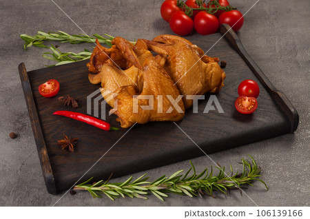 the wing is smoked boiled on a dark wooden board 106139166
