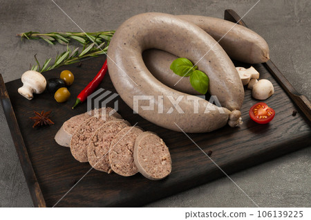 boiled sausage from offal on a dark wooden background 106139225
