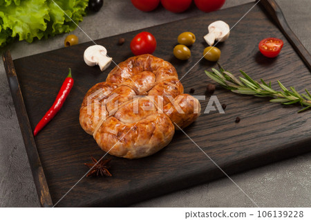 handmade boiled and smoked sausage on a dark wooden background handmade boiled and smoked sausage on a dark wooden background 106139228