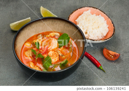 popular spicy Thai tom yam soup with shrimp. served with rice popular spicy Thai tom yam soup with shrimp. served with rice 106139241