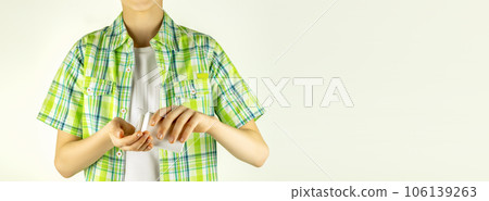 Boy pours vitamins omega 3 or vitamin D from a jar into his hand on light background. Child supplement vitamin pills at home for better immunity. Kid health care. Closeup, copy space, banner size Boy pours vitamins omega 3 or vitamin D from a jar into his hand on light background. Child supplement vitamin pills at home for better immunity. Kid health care. Closeup, copy space, banner size 106139263