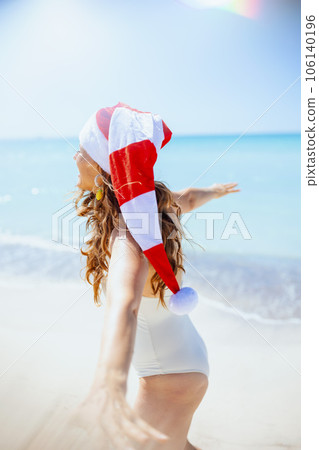 happy stylish female in white swimsuit having fun time at beach happy stylish female in white swimsuit having fun time at beach 106140196