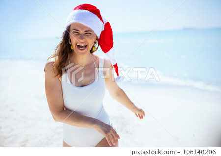 happy modern female in white beachwear having fun time at beach 106140206