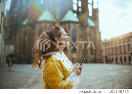 woman in Prague enjoying promenade and using smartphone woman in Prague enjoying promenade and using smartphone 106140725