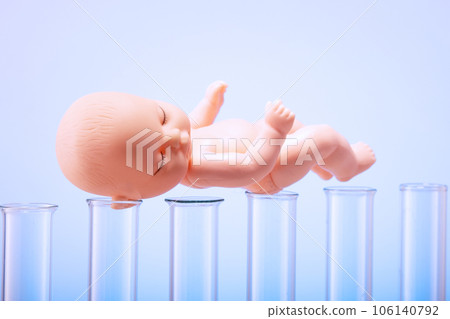 Figurine of a pupa on chemical test tubes. Concept of artificial insemination, test tube baby 106140792