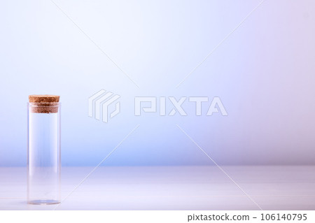 Empty glass bottle with cork on table with space for text Empty glass bottle with cork on table with space for text 106140795