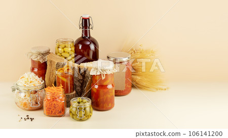 Probiotic food. Pickled or fermented products. Fermented vegetables and mushrooms in glass jars, bottle with home made beer and copy space. Home food preserving or canning. Preserving the harvest 106141200