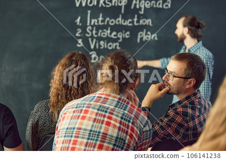 Confident male leader, coach talking with group of office workers, having good conversation with subordinate, discussing business strategy, ideas Confident male leader, coach talking with group of office workers, having good conversation with subordinate, discussing business strategy, ideas 106141238