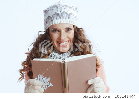 smiling trendy woman in sweater, mittens, hat and scarf on 106141444