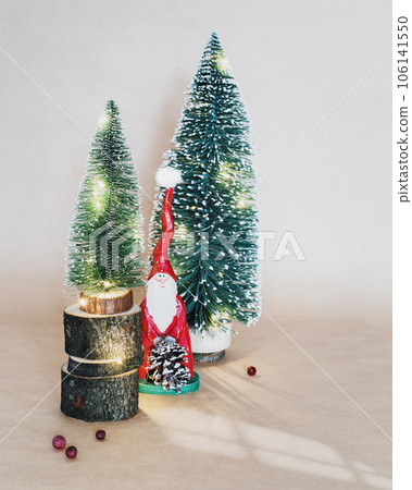 Selective focus, Merry Christmas and New Year holiday banner with a decorative Christmas trees and wooden Santa Claus on a craft background. Eco friendly New Year composition 106141550