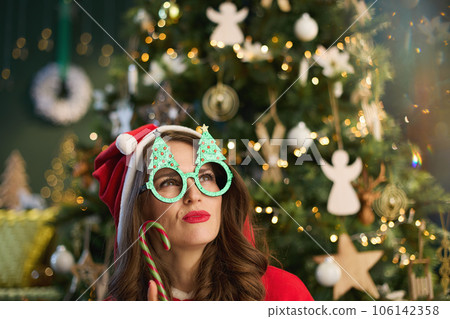 happy young woman with Santa hat in modern house 106142358