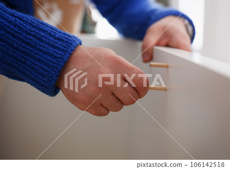 Male arms assembling furniture closeup Male arms assembling furniture closeup 106142518