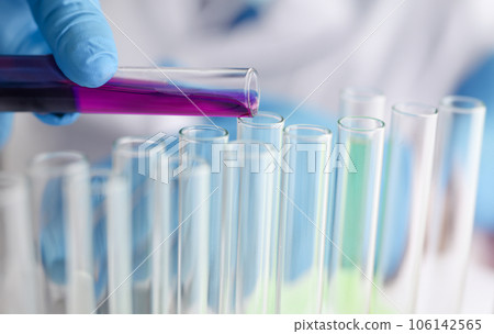 A male chemist holds test tube of glass 106142565