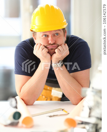 Thoughtful dummy funny worker in yellow helmet 106142579