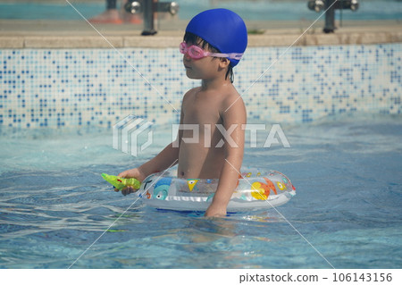 A kid swim in the pool. A kid swim in the pool. 106143156