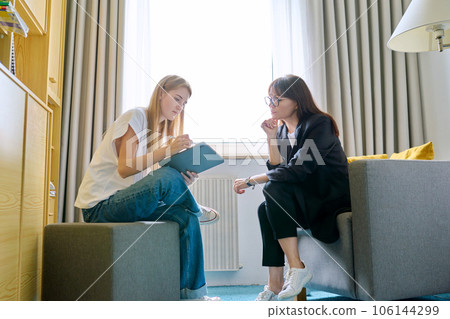 Young female at therapy meeting with psychotherapist 106144299