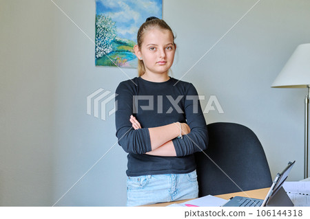Portrait of child girl 10 years old inside on background of light wall 106144318