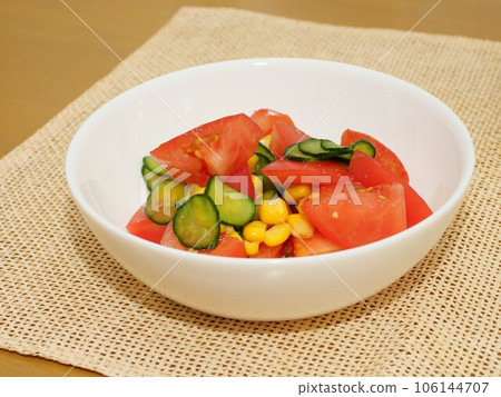 Tomato, corn and salted cucumber salad 106144707