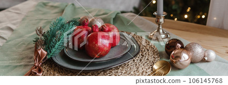 Serving a festive Christmas table in Scandinavian style. Decor on the table before the holiday. 106145768