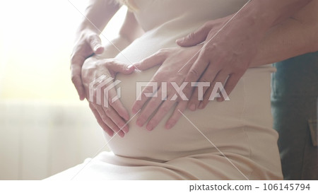 Pregnant couple husband and wife. family pregnancy expecting baby concept. man taking care of pregnant mother. baby in belly of a pregnant woman husband hugs belly guards takes lifestyle care 106145794