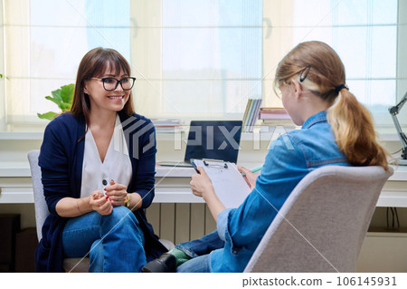 Pre-teen girl at therapy meeting with psychologist 106145931