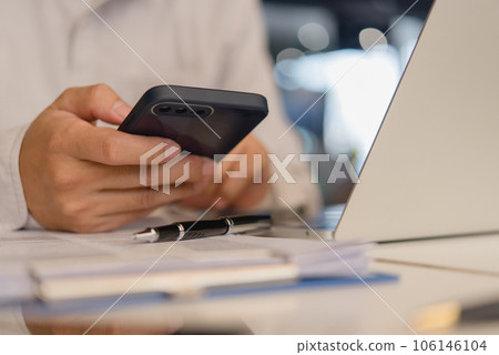 businessperson holding a mobile smartphone. work-related activity checking emails, messaging clients or coworkers, or browsing the web for research purposes. concept of technology and communication businessperson holding a mobile smartphone. work-related activity checking emails, messaging clients or coworkers, or browsing the web for research purposes. concept of technology and communication 106146104