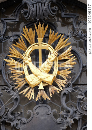 Franciscan monogram on the main entrance, Mariahilf church in Graz, Styria, Austria Franciscan monogram on the main entrance, Mariahilf church in Graz, Styria, Austria 106146157