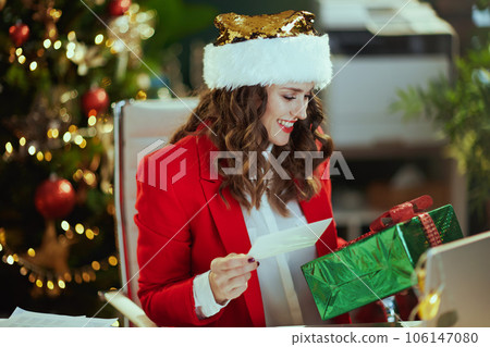 happy business owner woman in green office with Christmas tree 106147080
