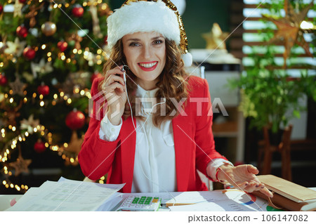 happy modern business woman in red jacket having video chat 106147082