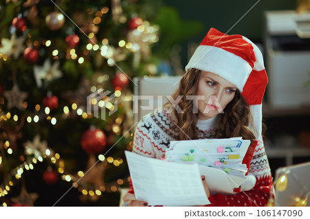 tired stylish working in green office with Christmas tree 106147090