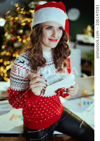 business owner woman in green office with Christmas tree 106147091