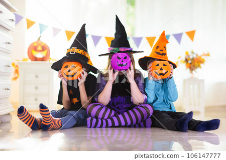Kids in witch costume on Halloween trick or treat 106147777