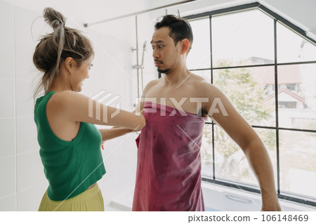 Funny and playful couple, wife helping husband after taking bath. 106148469
