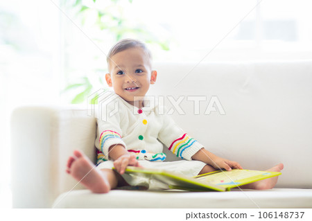 Baby boy reading a book. Kids read. 106148737