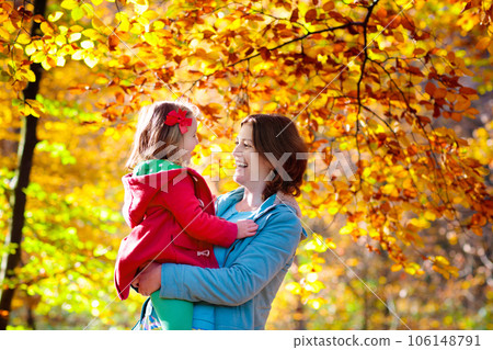 Mother and kid in autumn. Fall outdoor family fun. Mother and kid in autumn. Fall outdoor family fun. 106148791