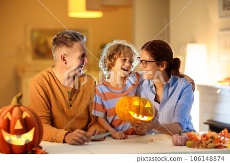 Family carving pumpkin. Halloween trick or treat 106148874