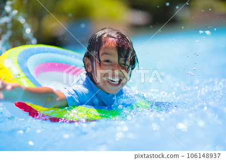 Child in swimming pool on toy ring. Kids swim. Child in swimming pool on toy ring. Kids swim. 106148937
