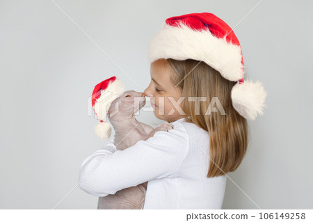Christmas portrait of happy cheerful lovely child girl Santa with cat Santa on white background Christmas portrait of happy cheerful lovely child girl Santa with cat Santa on white background 106149258